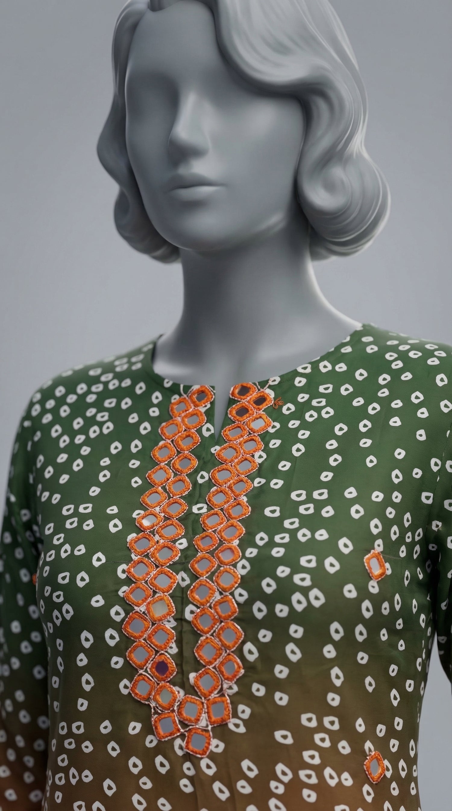 Hand embroidered neckline detail on green orange silk suit