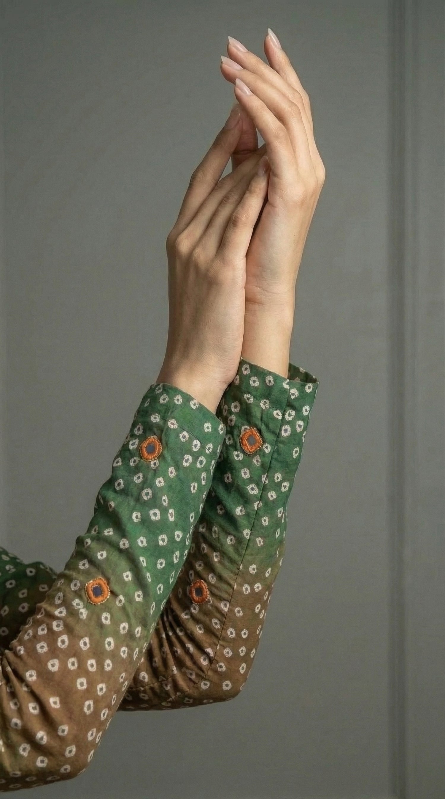 Close-up of hand embroidered silk with mirror and tila work

