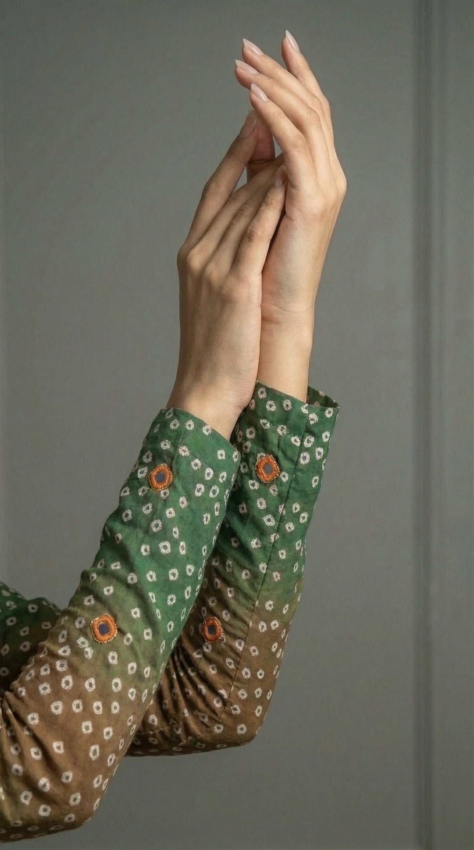 Close-up of hand embroidered silk with mirror and tila work
