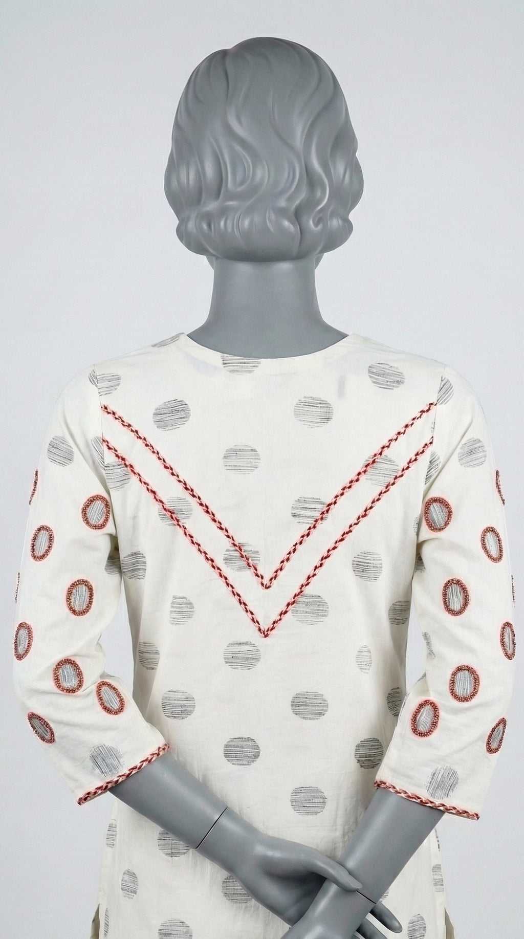 Stitched kurta style shirt with red and copper bead embellishments
