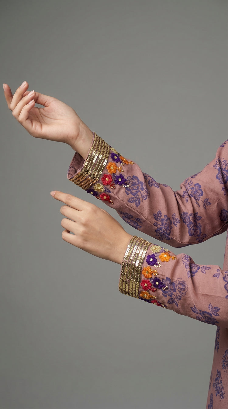 Close-up of hand embroidered Adda work on peach orange silk
