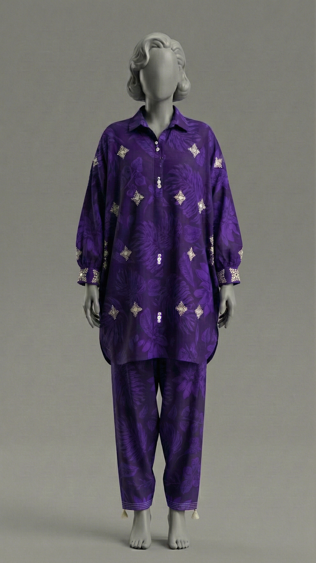 Purple baggy style stitched suit with Balochi embroidery and mirror work
