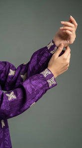 Detail of Balochi hand embroidery with mirror work on purple suit
