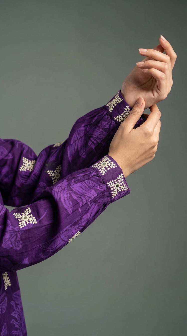 Detail of Balochi hand embroidery with mirror work on purple suit
