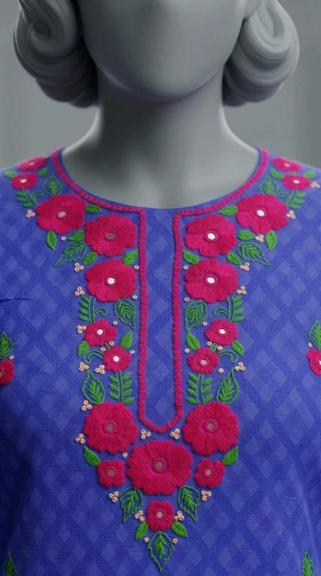 Close-up of hand embroidered neckline with sitara and mirror embellishments


