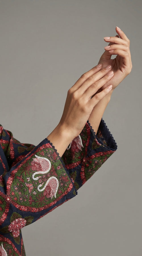 Close-up of hand embroidered Adda work with sitara on swan print
