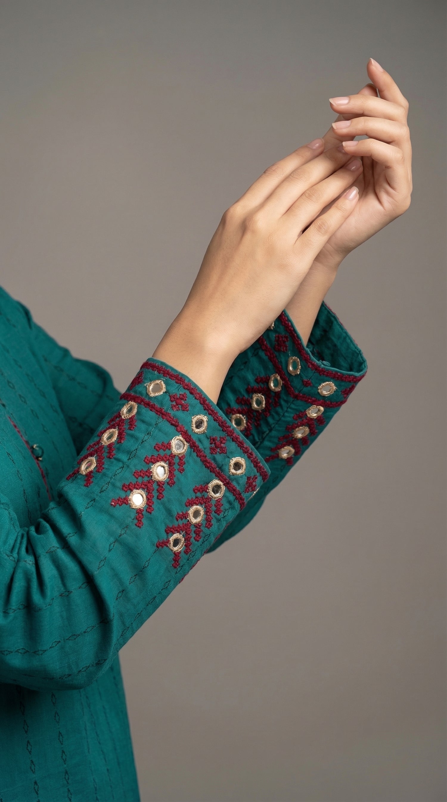 Close-up of hand embroidered Adda work with mirror details
